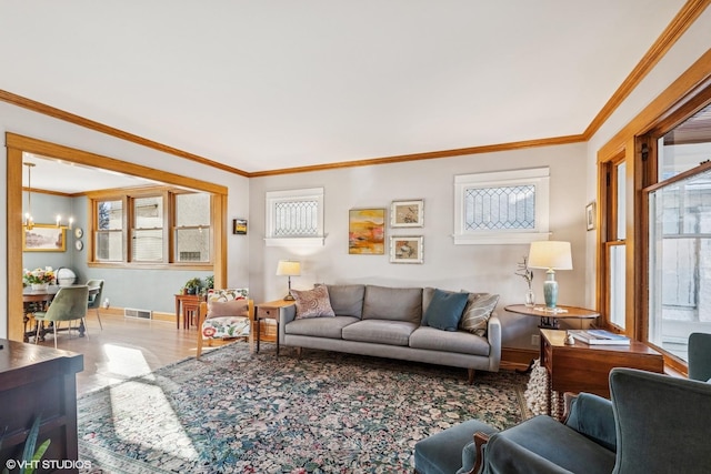 living room featuring visible vents, a wealth of natural light, and ornamental molding