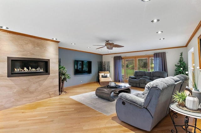 living area featuring ornamental molding, recessed lighting, baseboards, and wood finished floors