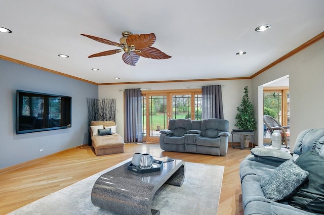 living room with a healthy amount of sunlight, baseboards, and wood finished floors