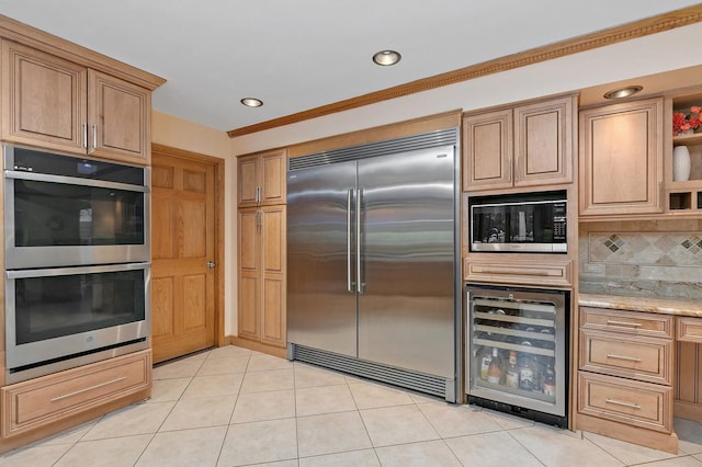 kitchen with beverage cooler, light stone counters, built in appliances, open shelves, and backsplash