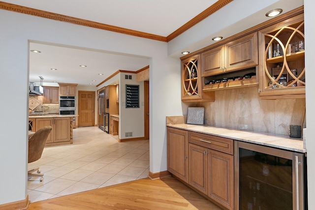 kitchen featuring light countertops, wine cooler, light tile patterned flooring, and crown molding