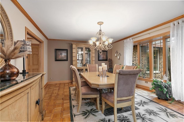 dining space with a chandelier, ornamental molding, and baseboards