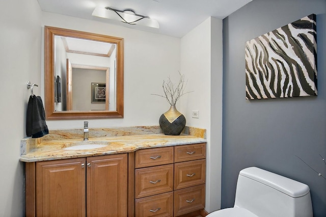 half bathroom featuring toilet and vanity