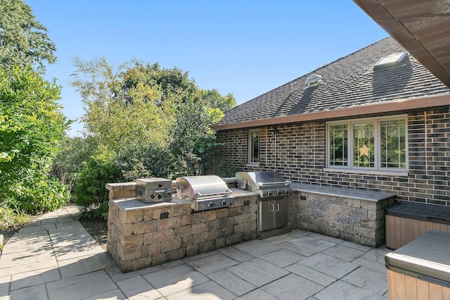 view of patio with an outdoor kitchen and area for grilling