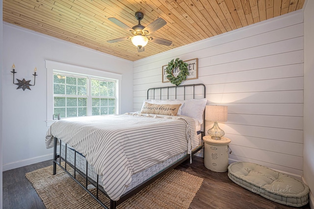 bedroom featuring wooden ceiling, ceiling fan, baseboards, and wood finished floors