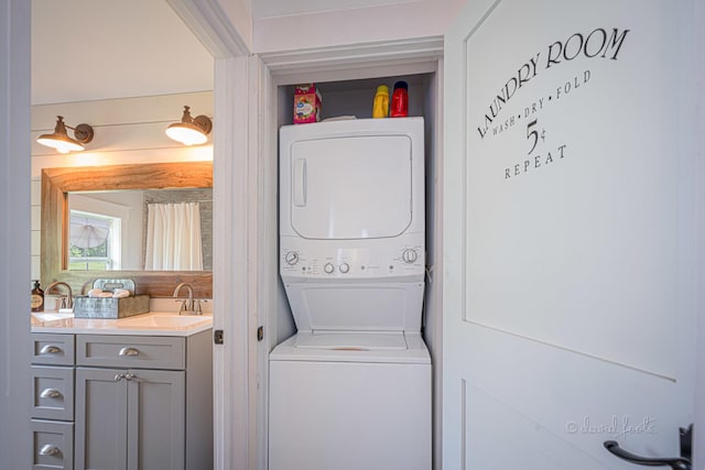 laundry room featuring a sink, laundry area, and stacked washer / drying machine