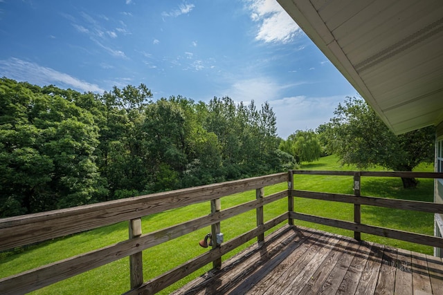 wooden terrace with a lawn