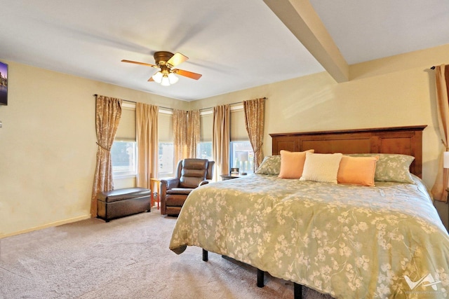 bedroom featuring baseboards, ceiling fan, beamed ceiling, and light colored carpet