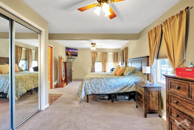 bedroom featuring light carpet and ceiling fan