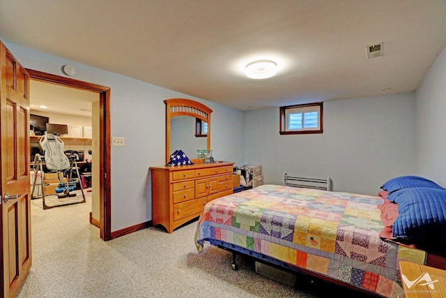 bedroom with baseboards, visible vents, and light colored carpet