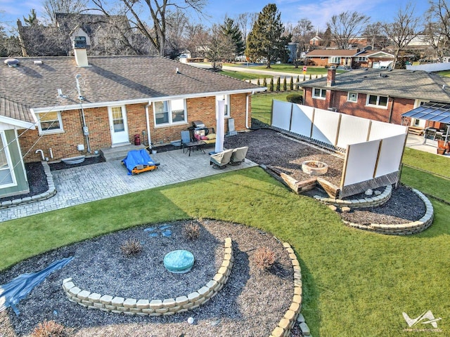 exterior space featuring a patio area, fence, and a fire pit