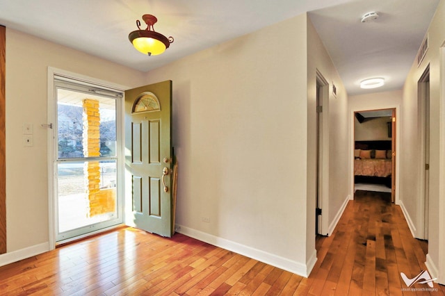 entrance foyer with baseboards and light wood finished floors