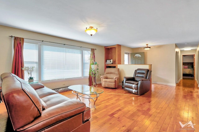 living area featuring light wood finished floors and baseboards