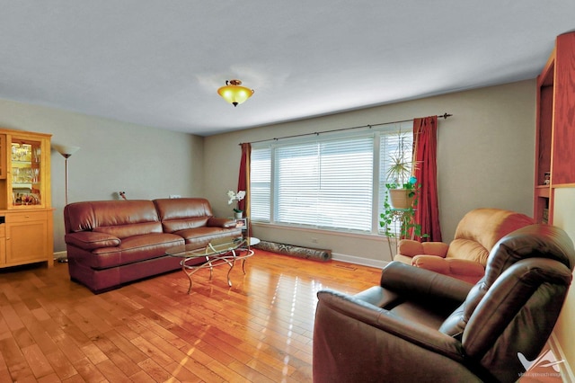 living room with light wood finished floors and baseboards