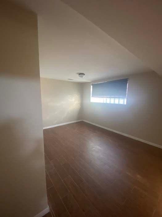 interior space with dark wood-style floors and baseboards