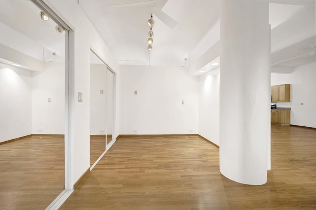 spare room with light wood-style floors and baseboards