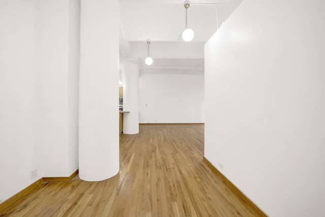 interior space with wood finished floors and baseboards