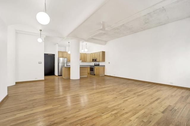 unfurnished living room with light wood-style floors, ceiling fan, and baseboards