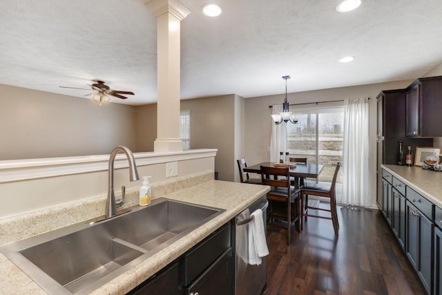 kitchen with recessed lighting, dark wood-type flooring, a sink, a textured ceiling, and dishwasher