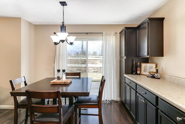 dining room with dark wood-style floors, baseboards, and a chandelier