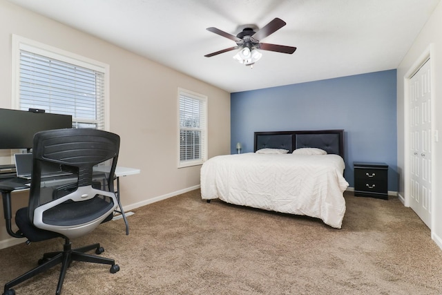 bedroom with carpet floors, baseboards, and a closet