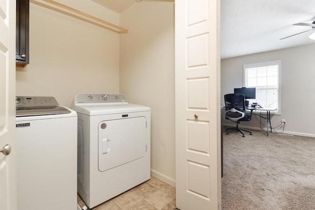 laundry area with light colored carpet, cabinet space, a ceiling fan, separate washer and dryer, and baseboards