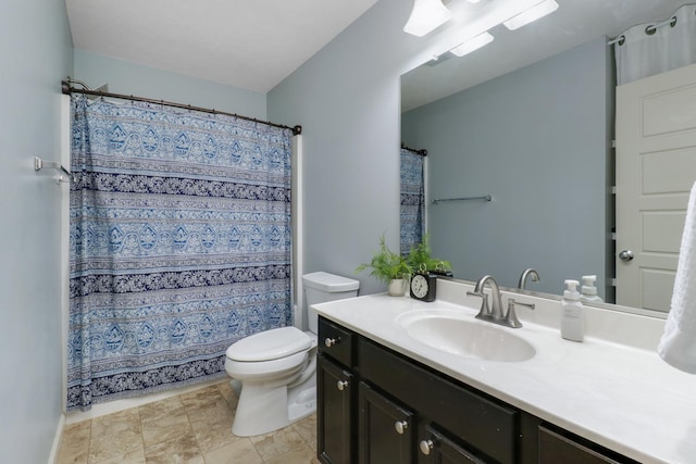 full bath featuring curtained shower, vanity, and toilet