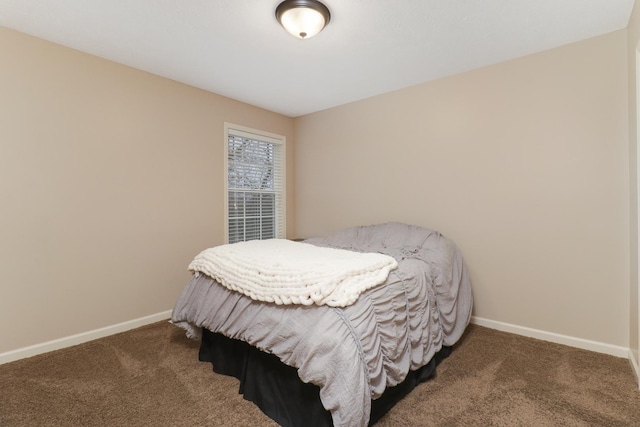 bedroom with carpet floors and baseboards