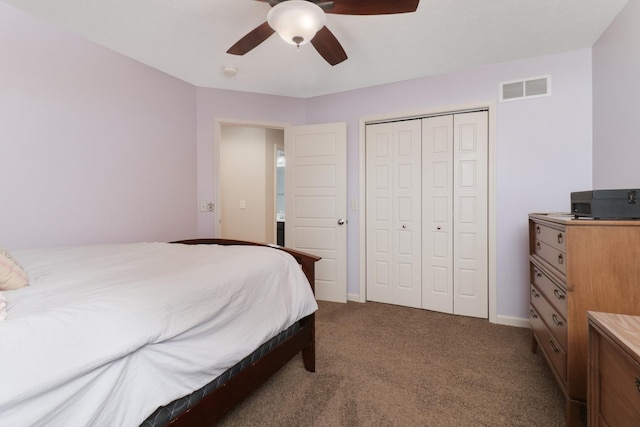 carpeted bedroom featuring baseboards, ceiling fan, visible vents, and a closet