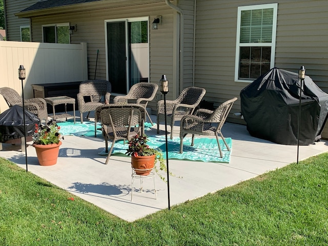 view of patio / terrace featuring a grill, fence, and an outdoor living space