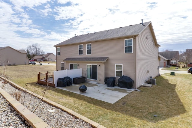 rear view of property featuring central AC, a patio, and a lawn