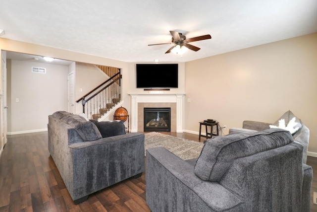 living area with baseboards, visible vents, stairway, dark wood-style flooring, and a fireplace