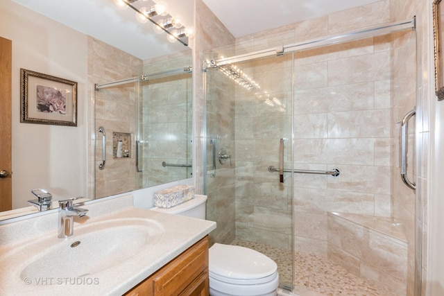 full bath with vanity, toilet, and a stall shower