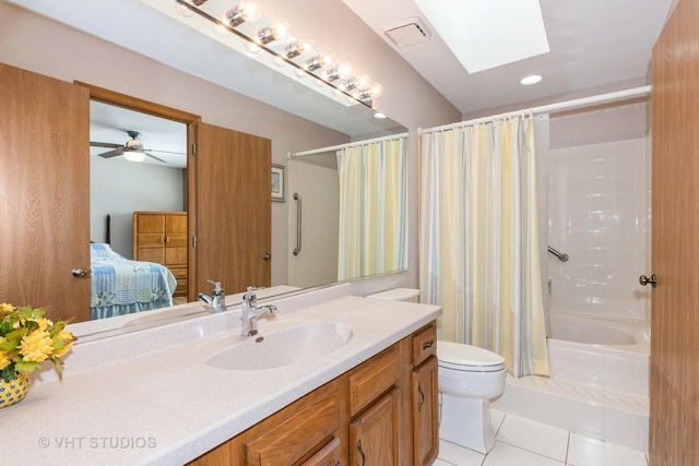 full bath with vanity, a skylight, tile patterned flooring, ensuite bathroom, and toilet