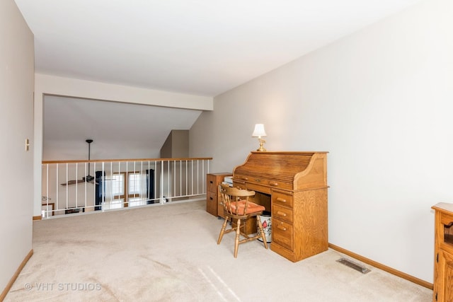 office with visible vents, lofted ceiling, baseboards, and carpet floors