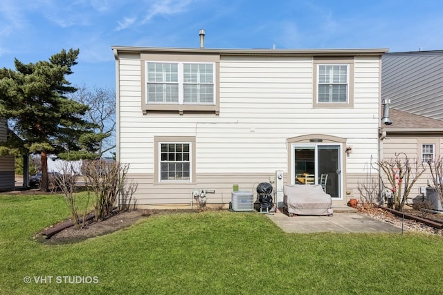 back of house featuring a yard and a patio area