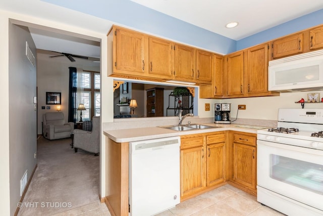 kitchen with white appliances, visible vents, ceiling fan, a sink, and light countertops