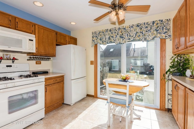 kitchen featuring white appliances, a ceiling fan, brown cabinetry, recessed lighting, and light countertops