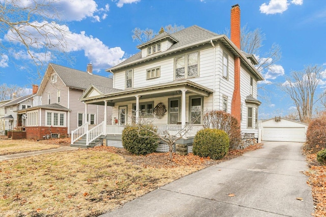 american foursquare style home with covered porch, a shingled roof, an outdoor structure, a detached garage, and a chimney