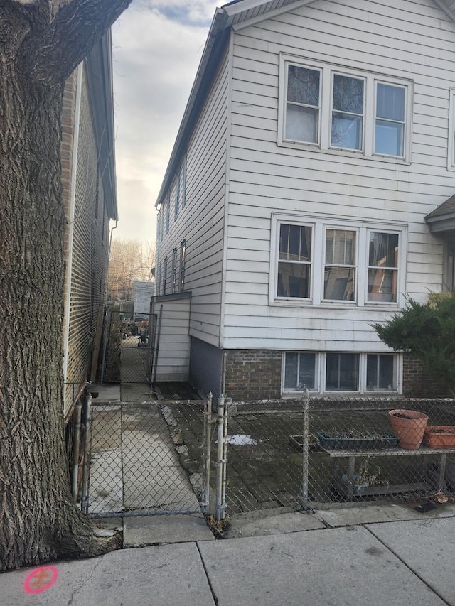 view of side of property with a gate and fence