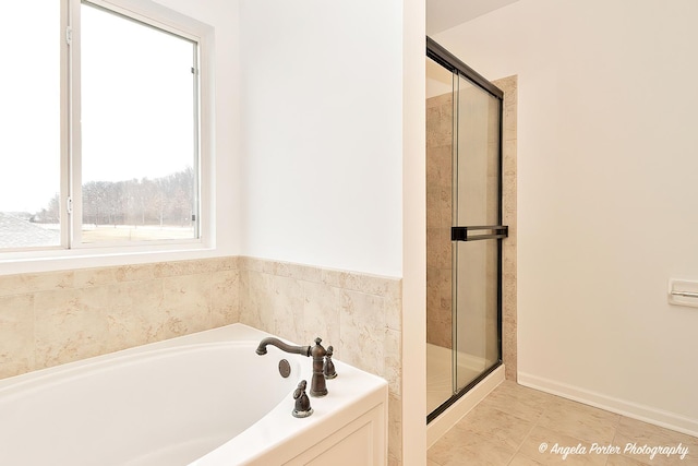 bathroom with tile patterned flooring, a shower stall, and a bath