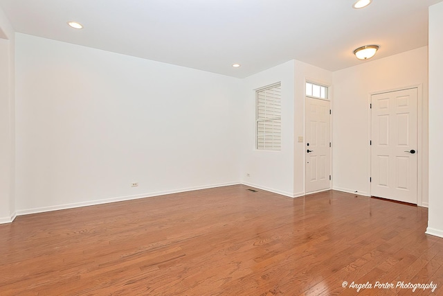 entryway featuring recessed lighting, baseboards, and wood finished floors