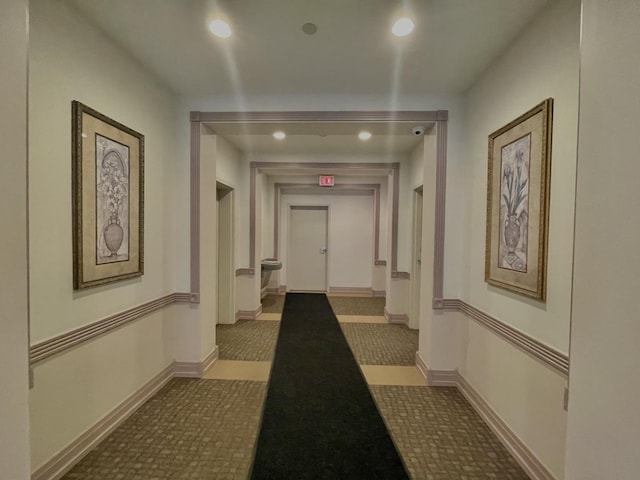 hall featuring recessed lighting and baseboards