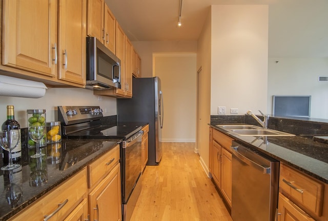 1322 S Prairie Ave Unit 1413, Chicago, IL 60605 - kitchen featuring stainless steel appliances, light wood-style flooring, dark stone countertops, brown cabinetry, and rail lighting