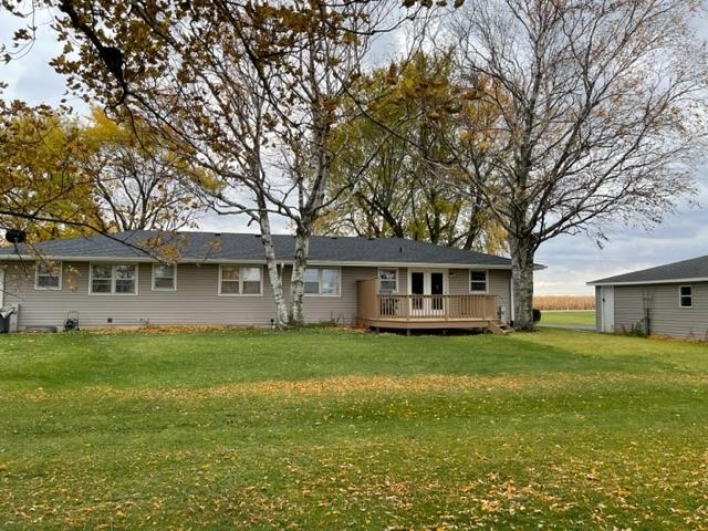 view of front facade with a front lawn and a wooden deck