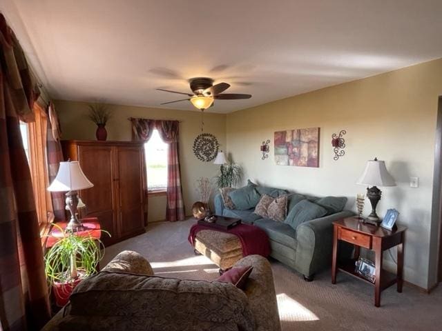 living area with ceiling fan and light colored carpet