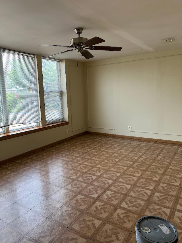 unfurnished room featuring light floors and baseboards