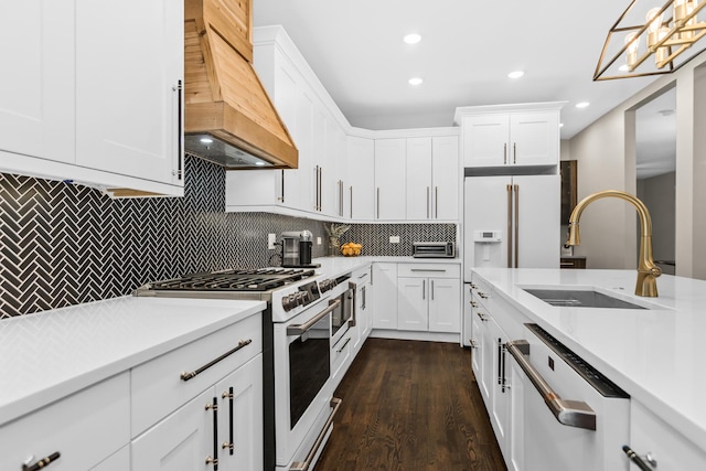 kitchen featuring light countertops, white cabinets, a sink, white appliances, and premium range hood