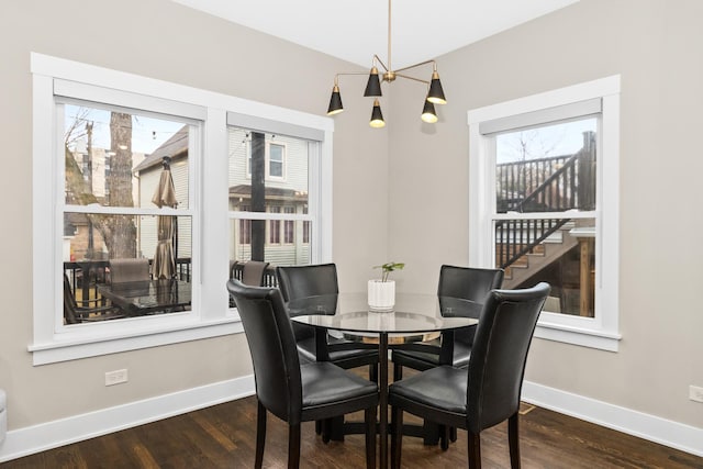 dining room with baseboards and wood finished floors