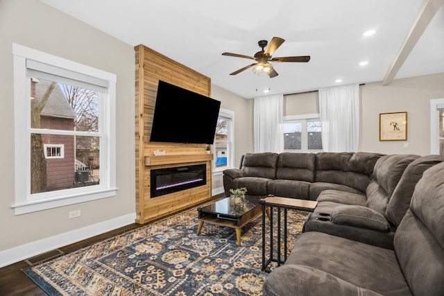 living room with a fireplace, recessed lighting, visible vents, wood finished floors, and baseboards